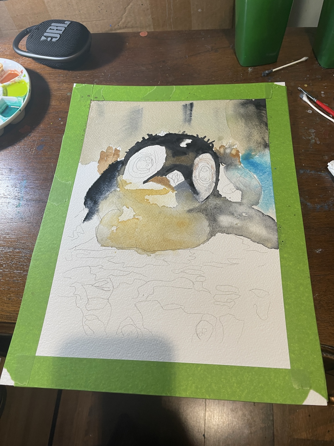 Penguin watercolor in progress, taped to Bryan Brouwer’s work table